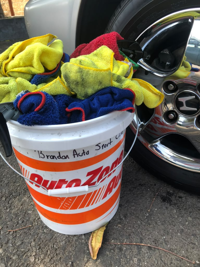 An AutoZone bucket, a few towels, and the first client tools.