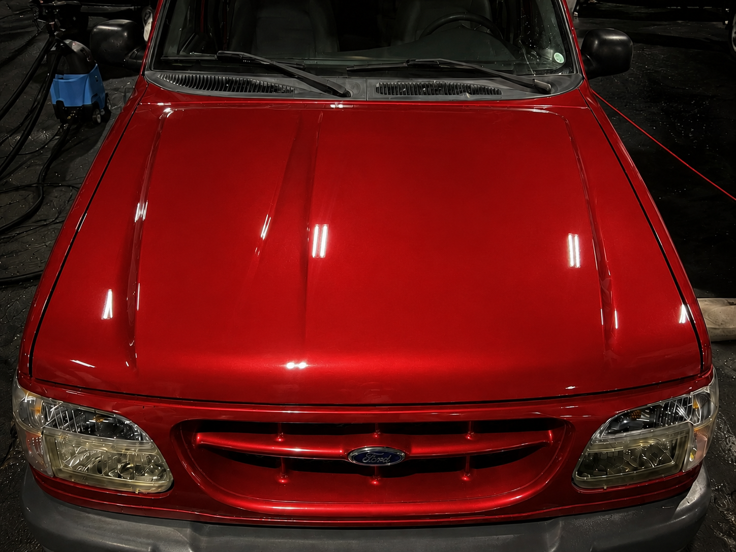 Paint correction and 7-year ceramic coating on a red Ford SUV — after
